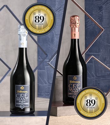 Zwei Flaschen Crémant stehen auf einem eleganten Tisch, umgeben von geometrischen Formen und Auszeichnungen für Qualität.